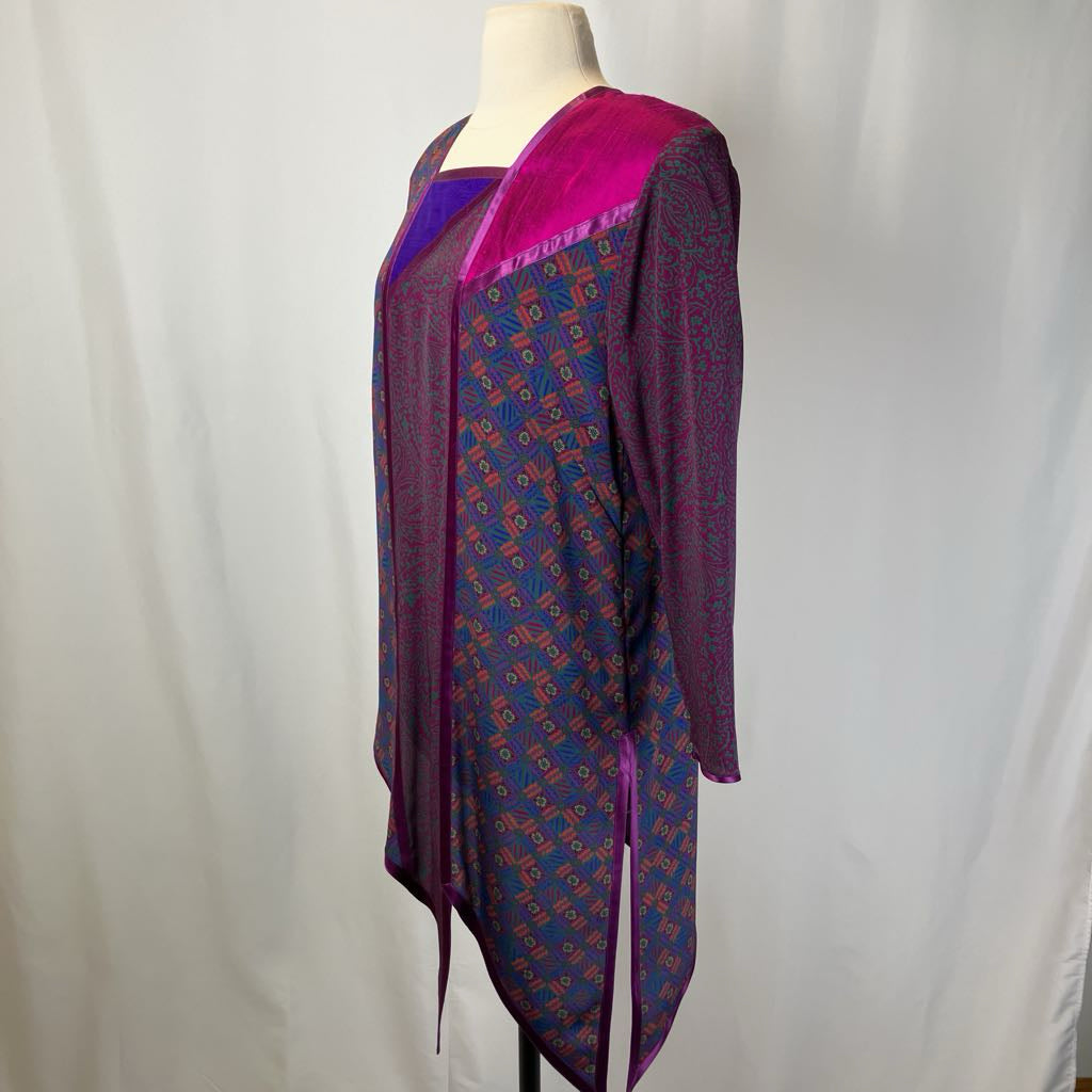 Mannequin wearing a patterned dress with a bright pink top against a plain background