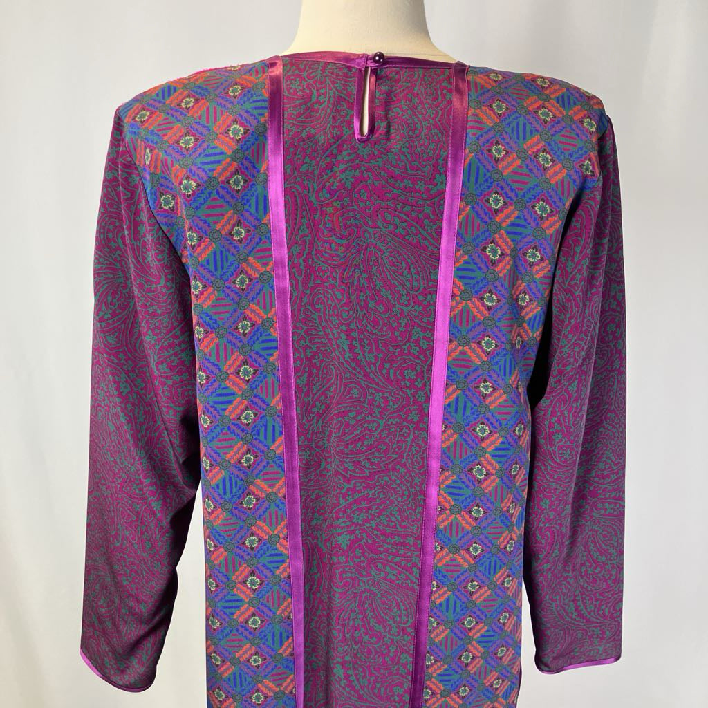 Colorful patterned shirt on a mannequin with a plain background
