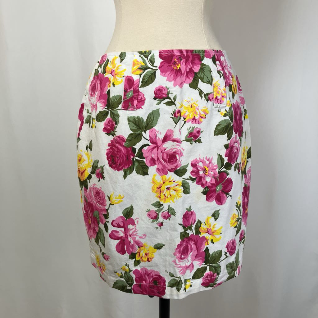Floral skirt on a mannequin against a plain background