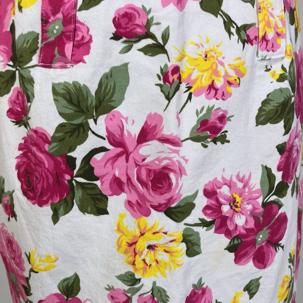 Floral patterned fabric with pink and yellow flowers on a white background