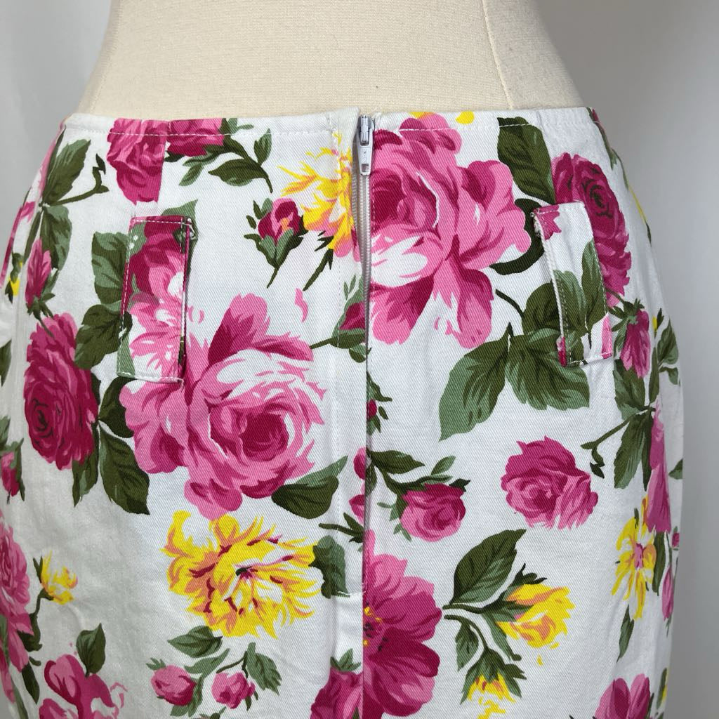 Floral skirt on a mannequin with pink roses and yellow flowers on a white background