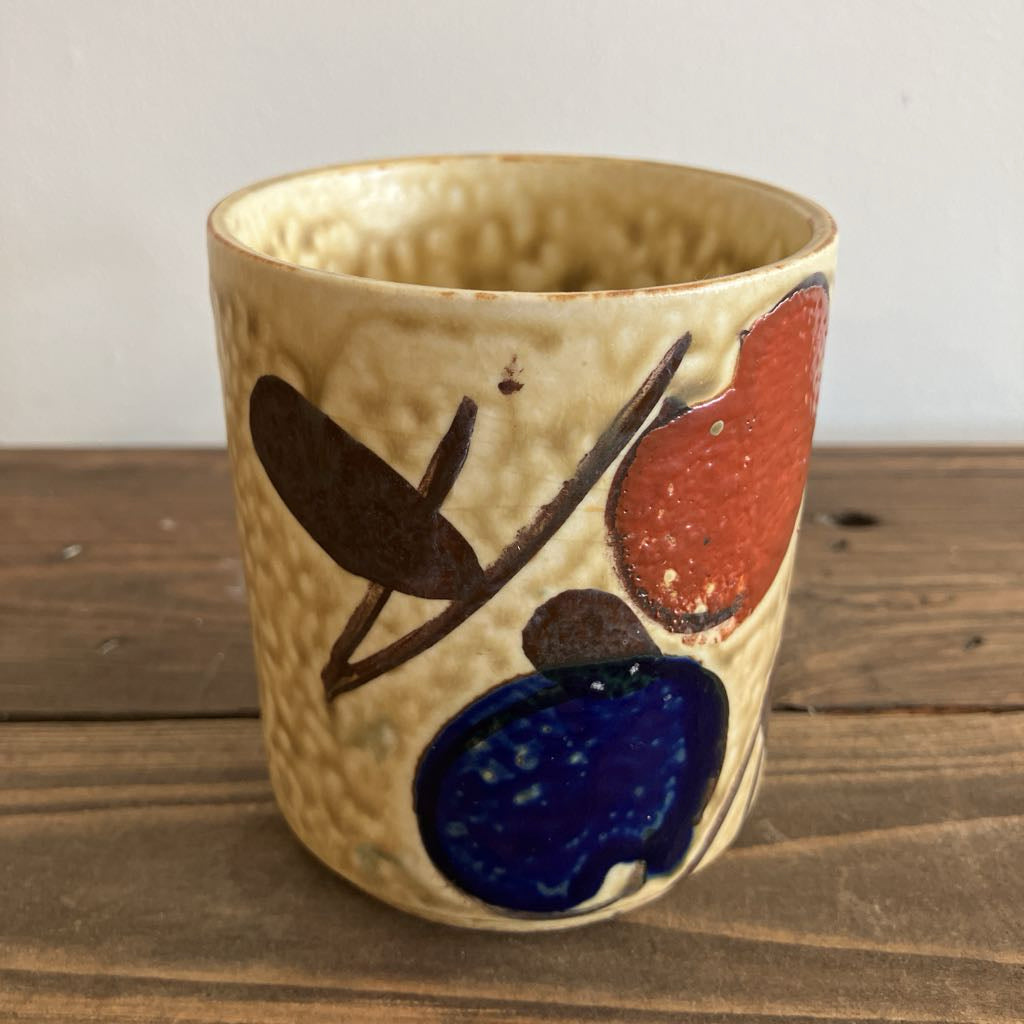 Ceramic cup with artistic designs on a wooden surface