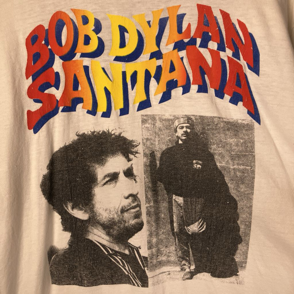 T-shirt with Bob Dylan and Santana text and images on a beige background
