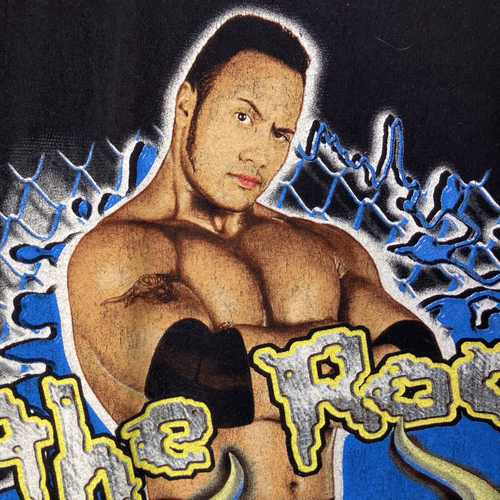 Wrestler with 'The Rock' text and graphics on a dark background