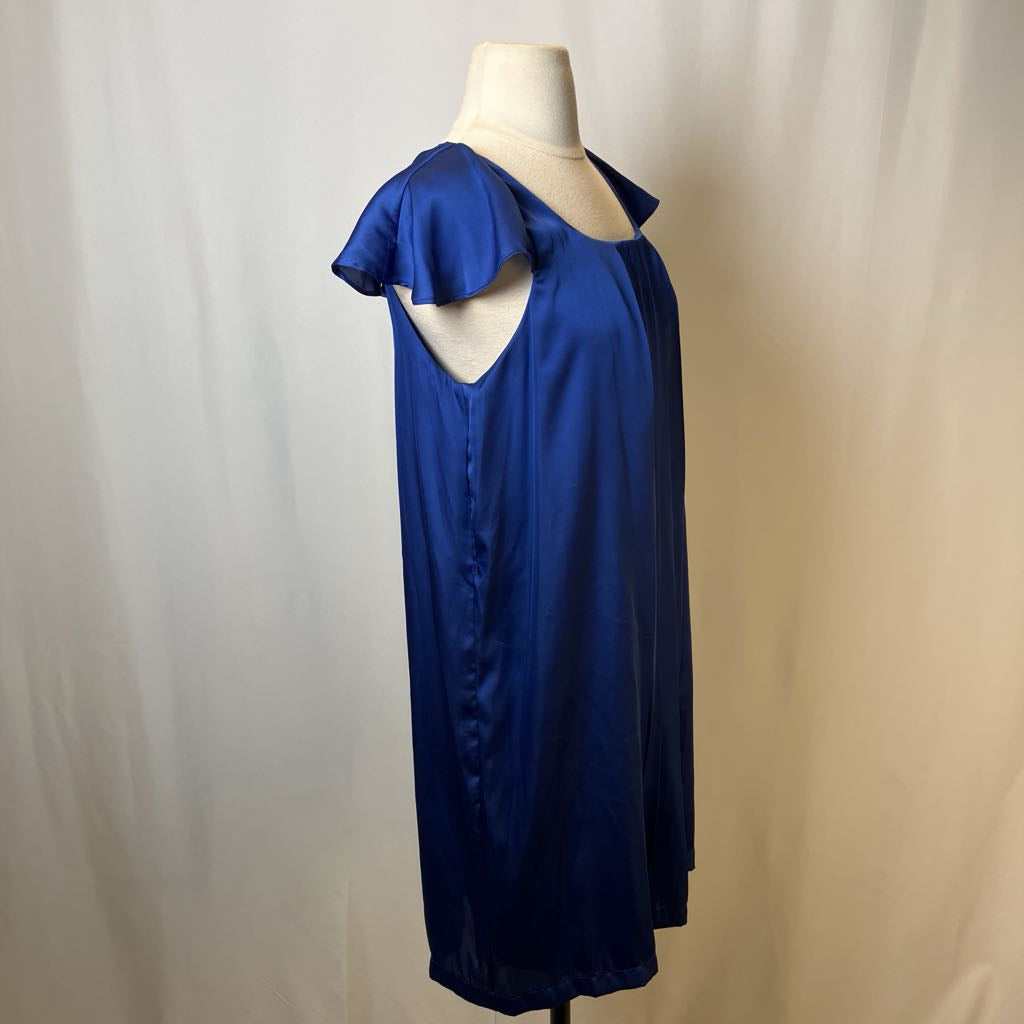 Blue dress on a mannequin against a plain background