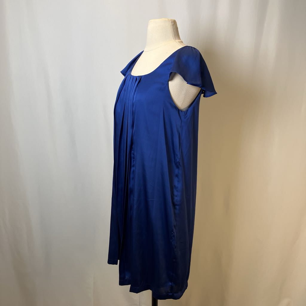 Blue dress on a mannequin against a plain background
