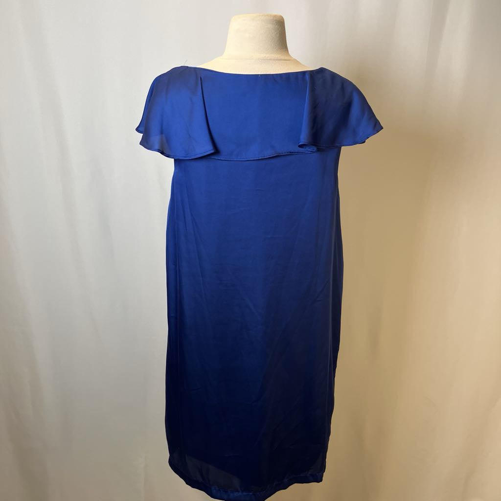 Blue dress on a mannequin against a plain background