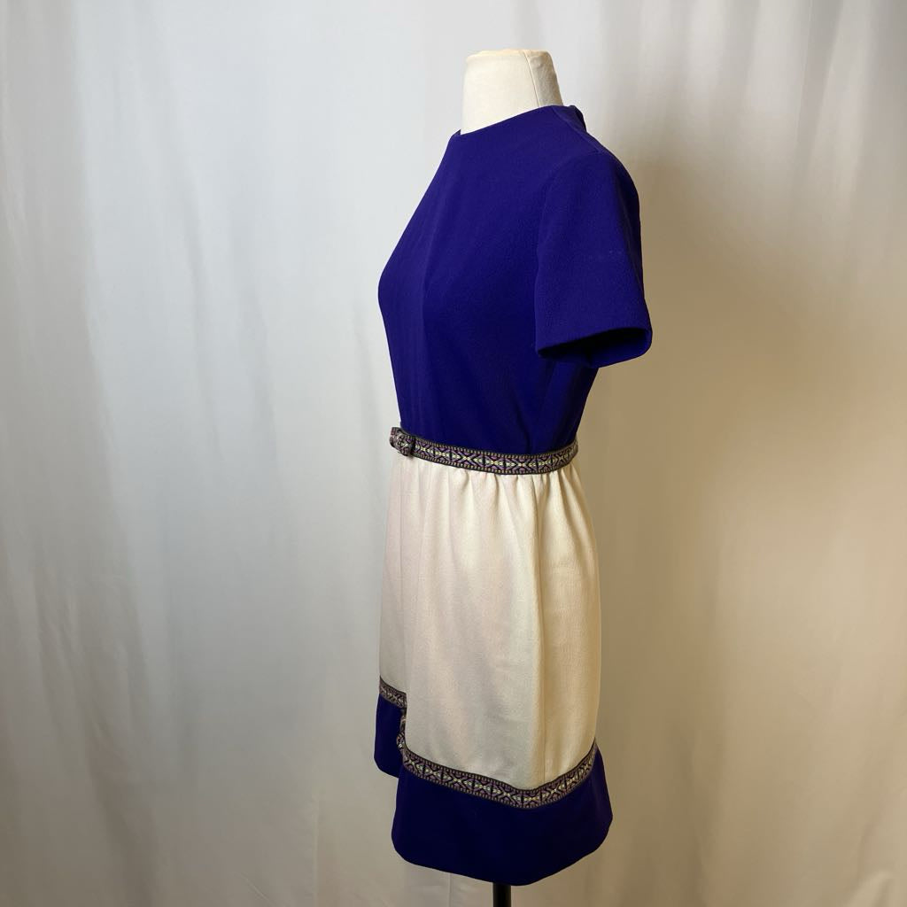 Mannequin wearing a dress with a blue top and white skirt against a plain background