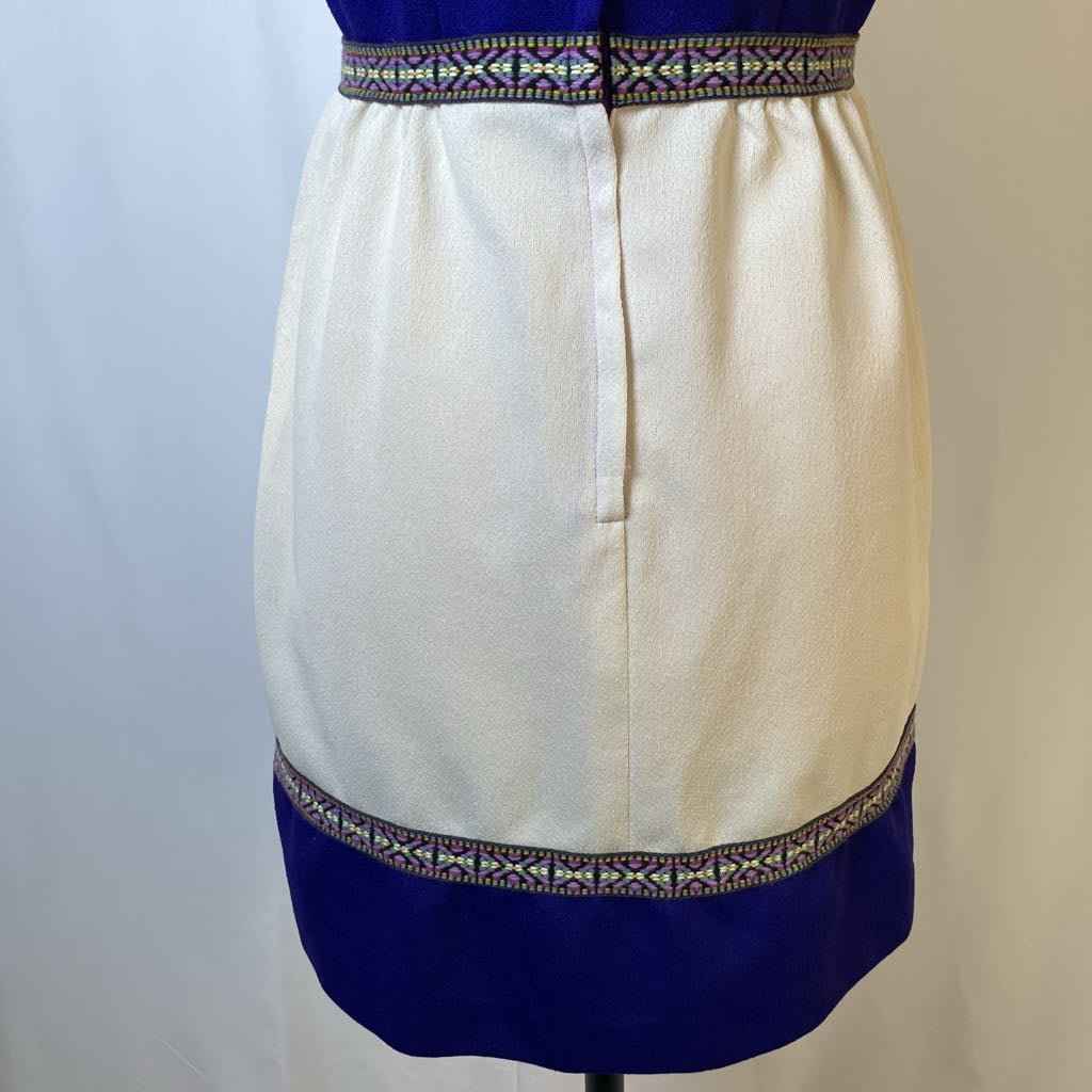 Skirt with white top half and blue bottom half on a mannequin against a plain background