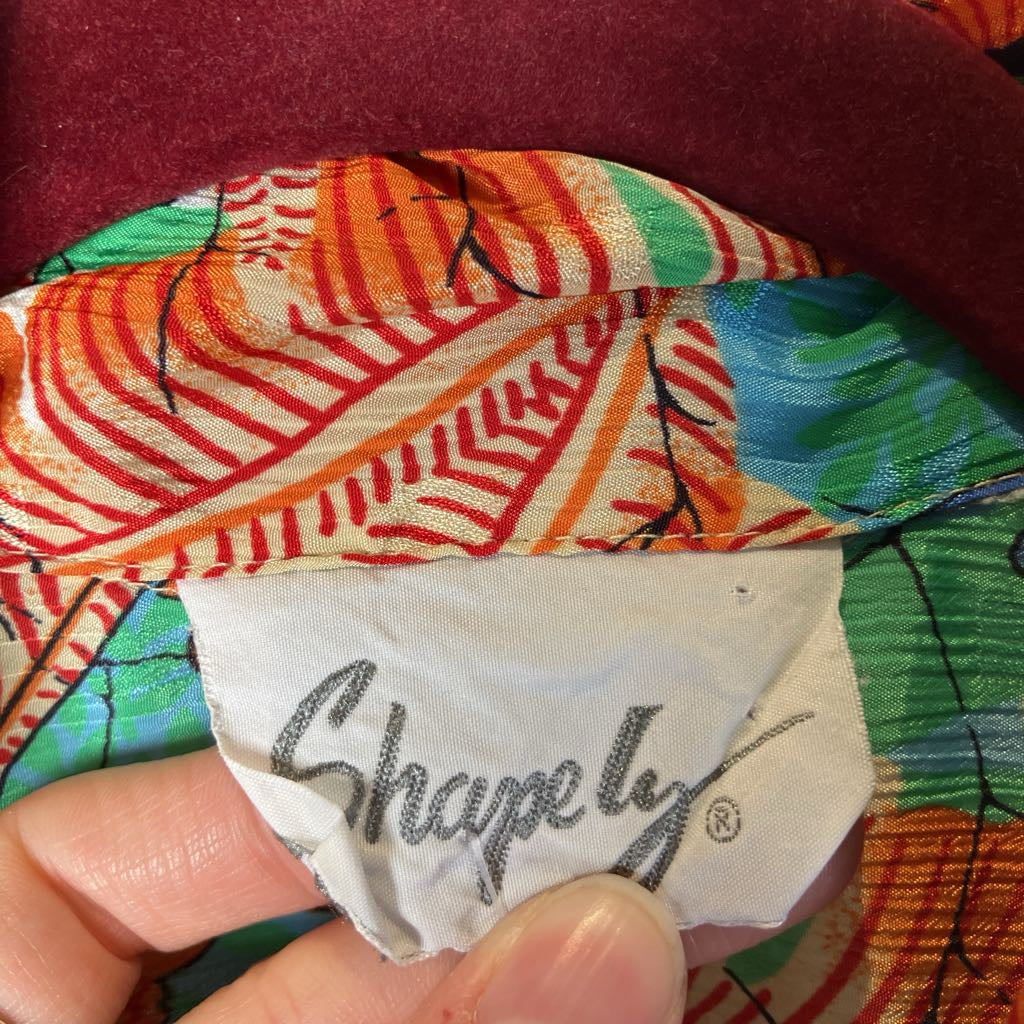 Colorful fabric with 'Shapely' branding held by a hand