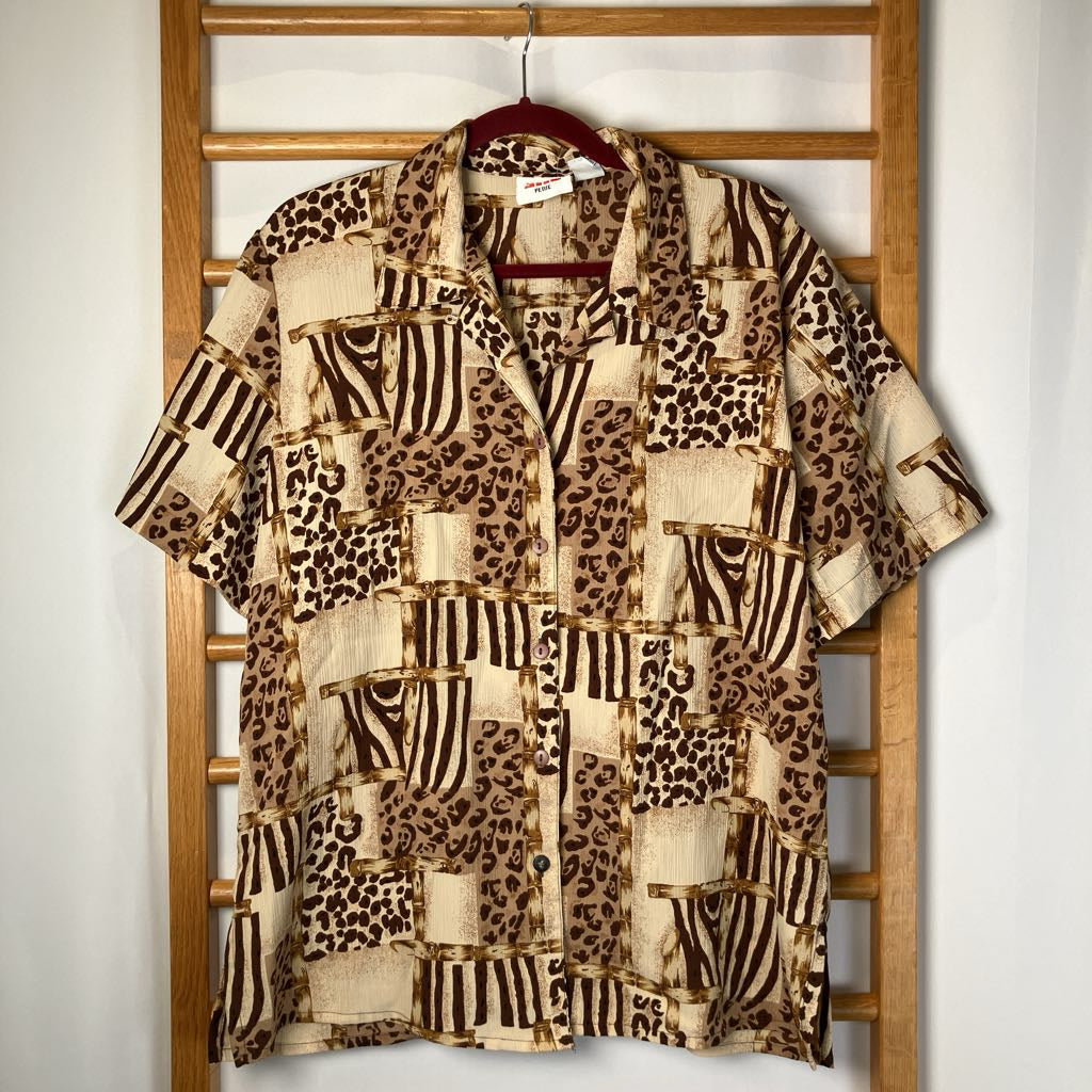 Patterned shirt on a hanger against a wooden rack