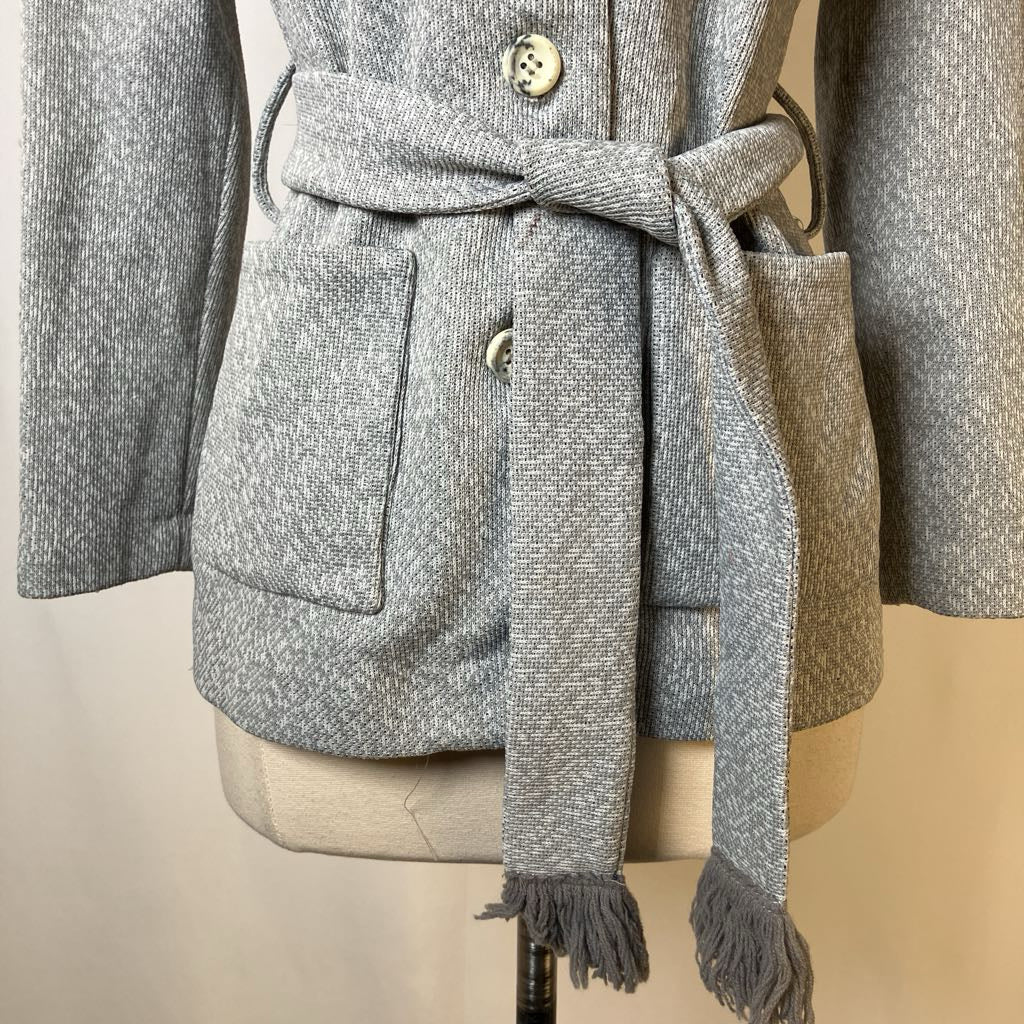 Gray textured coat with a matching scarf on a mannequin against a neutral background