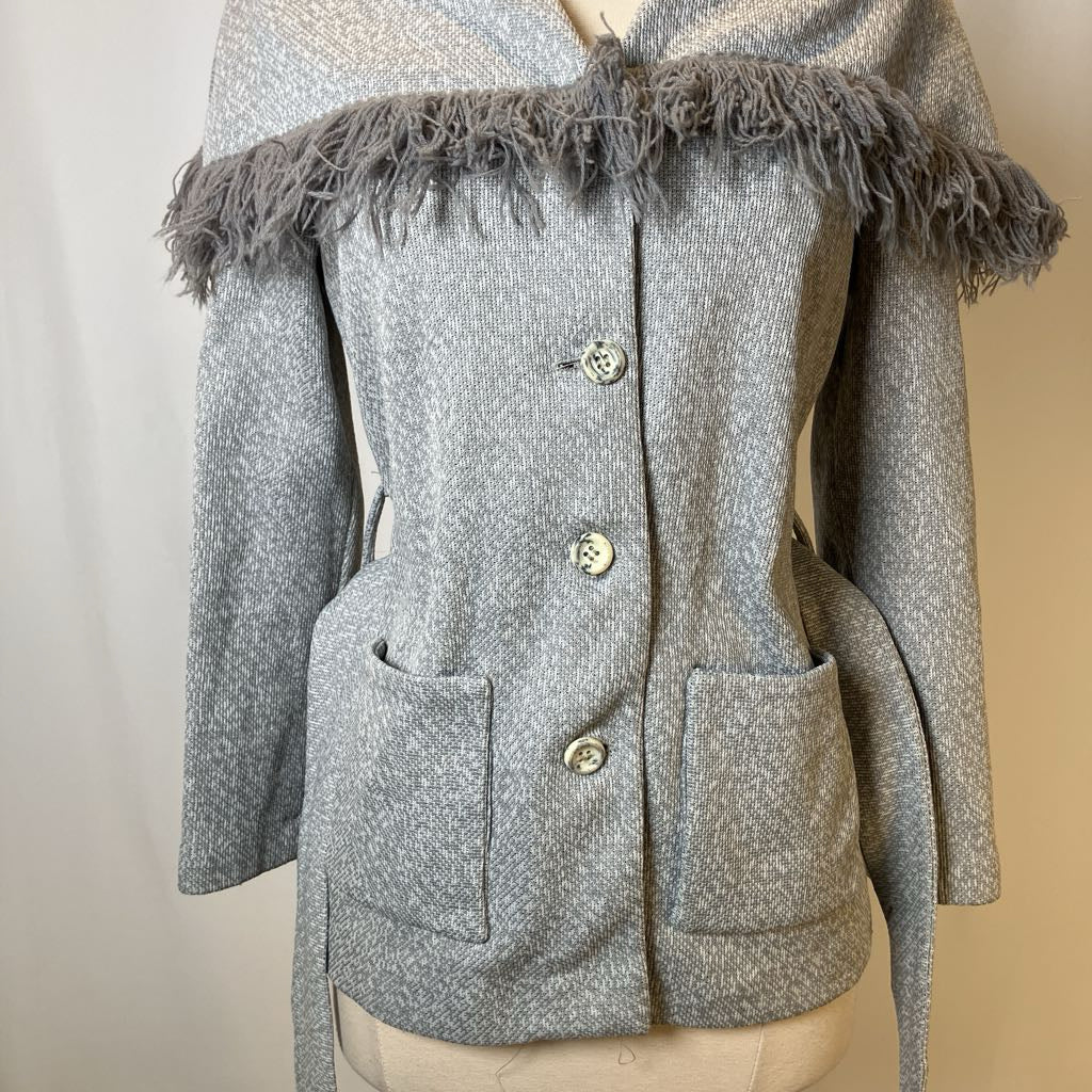 Gray textured jacket with frayed trim on a mannequin against a neutral background