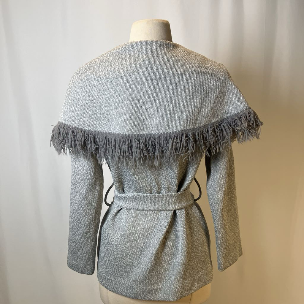 Gray textured jacket with fringe details on a mannequin against a neutral background