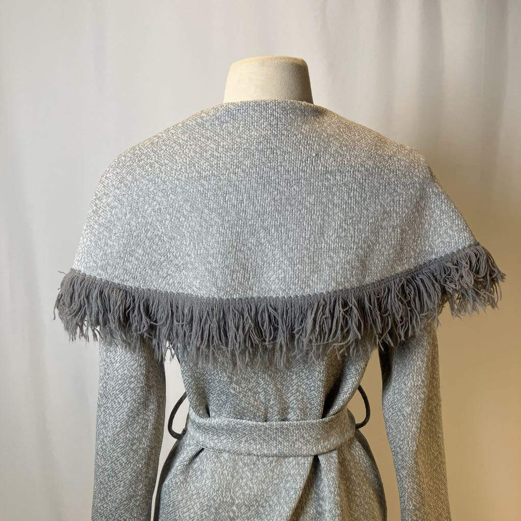 Gray textured shawl with fringe on a mannequin against a neutral background