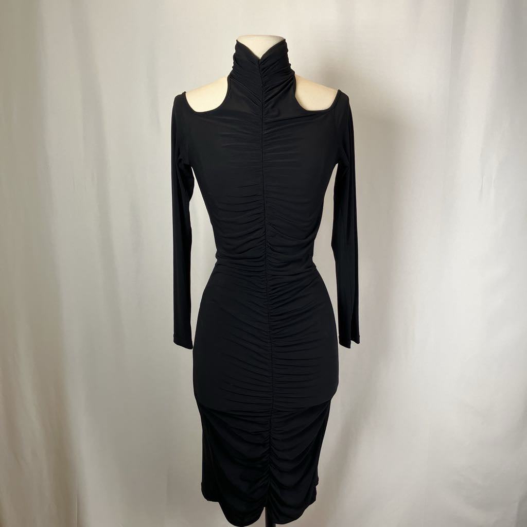 Black dress on a mannequin against a plain background