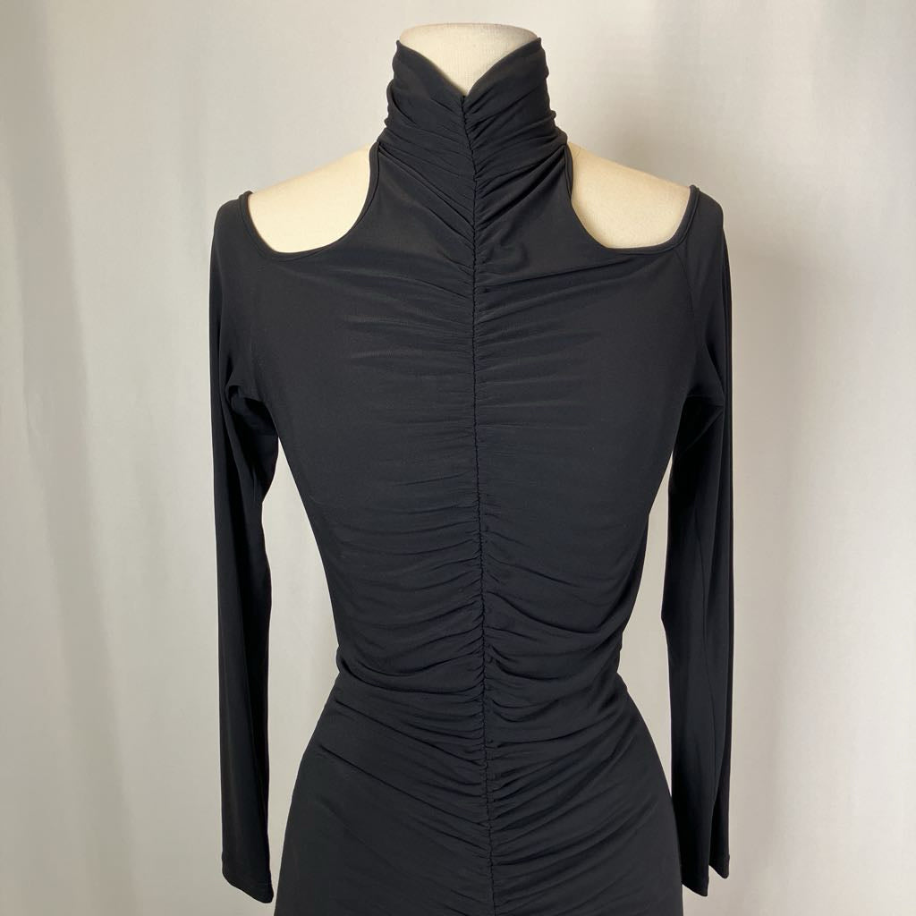 Black dress on a mannequin against a plain background