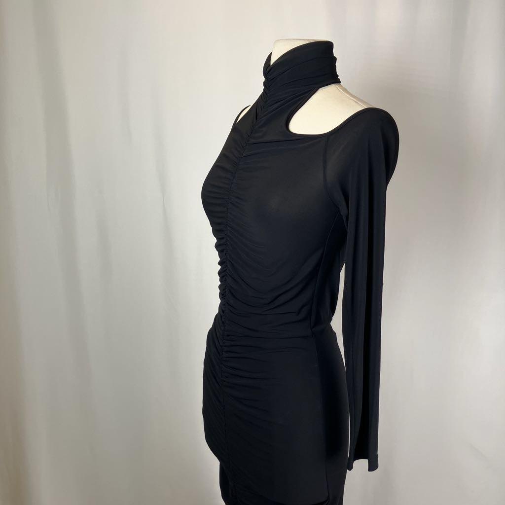 Black dress on a mannequin against a plain background