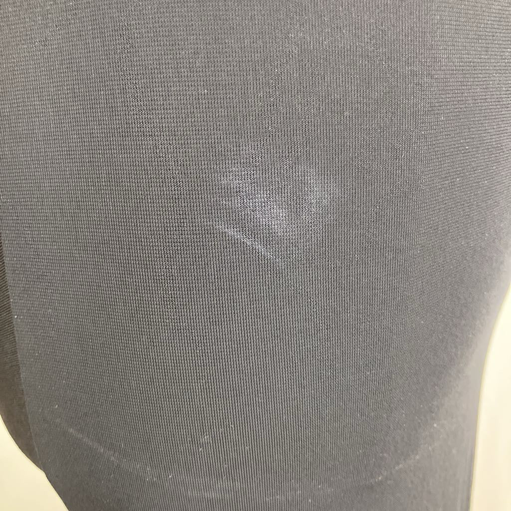 Close-up of a gray fabric with a visible stain.
