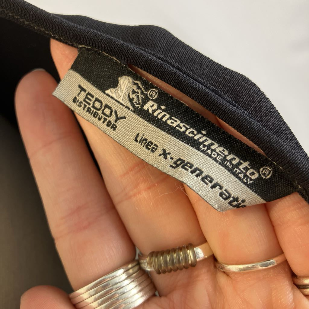 Close-up of a label on a product held by a hand, with visible text and branding.