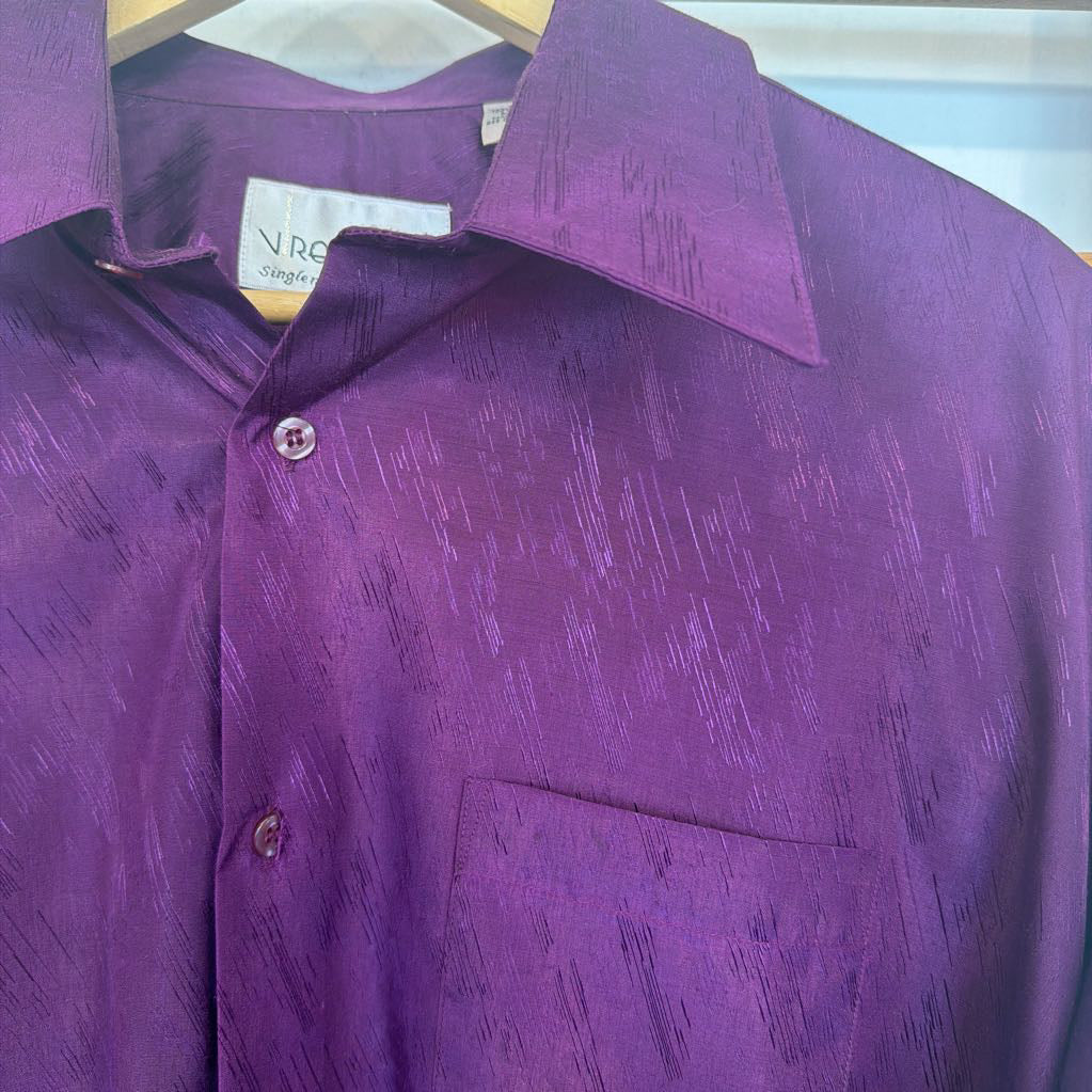 Purple patterned shirt on a hanger with a visible brand label.