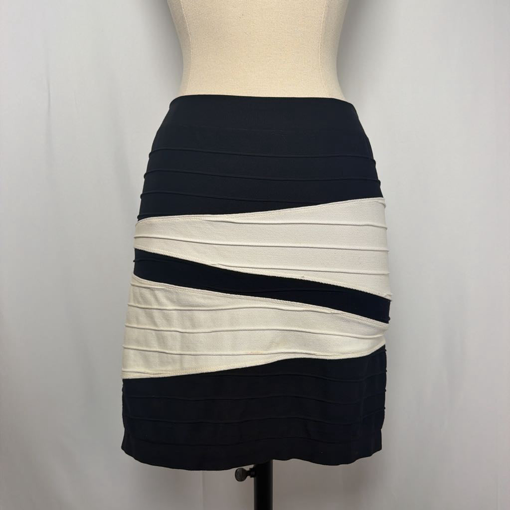 Black and white geometric patterned skirt on a mannequin in front of a white wall.