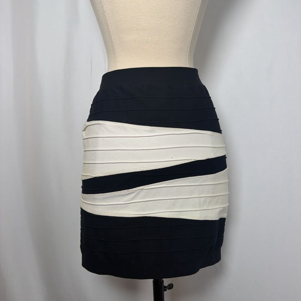 Black and white geometric patterned skirt on a mannequin in front of a white wall.