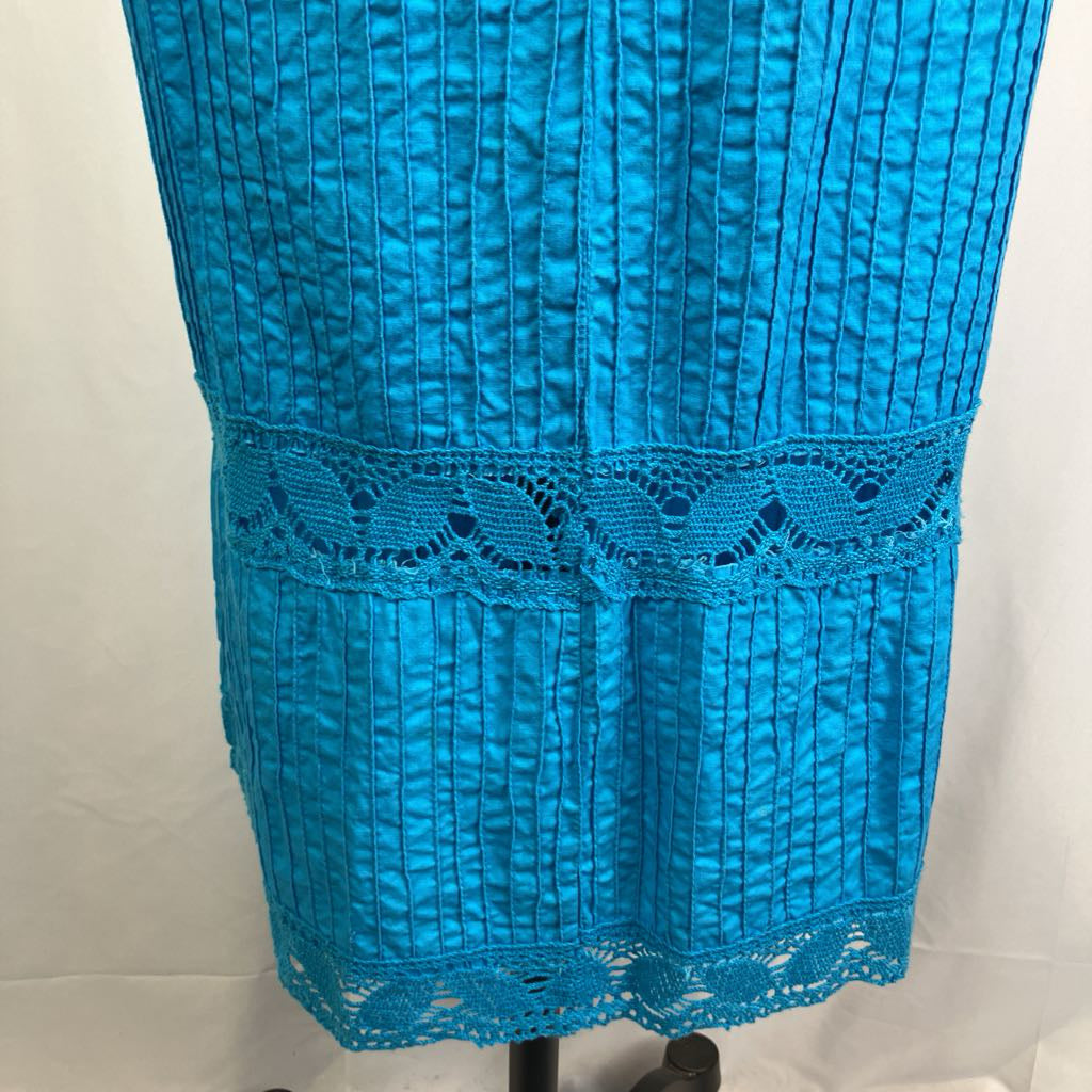 Blue dress with textured fabric and lace detail on a white background