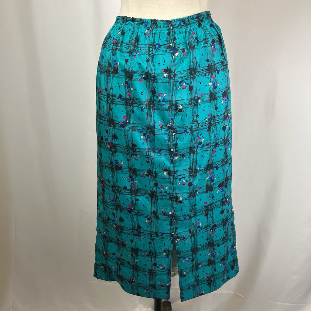 Teal skirt with black and multicolor pattern on a mannequin against a white background