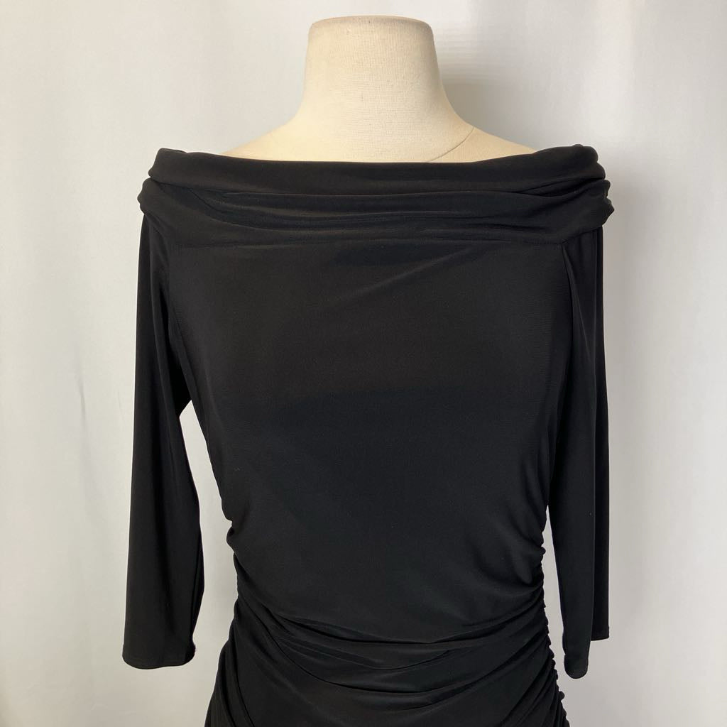 Black off-shoulder dress on a mannequin against a plain background