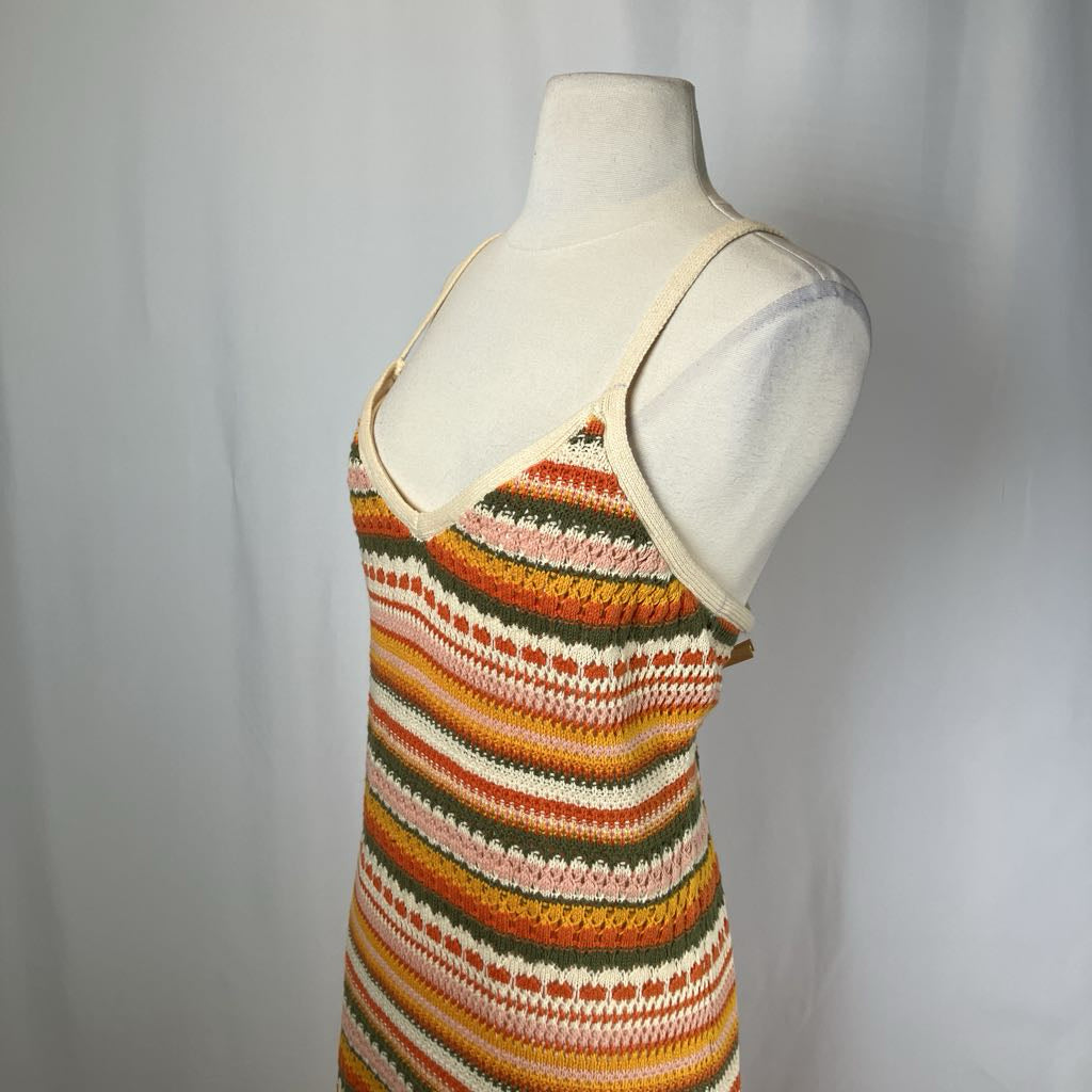 Colorful striped tank top on a mannequin against a plain background