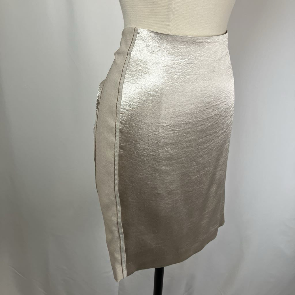 Silver metallic skirt on a mannequin against a plain background