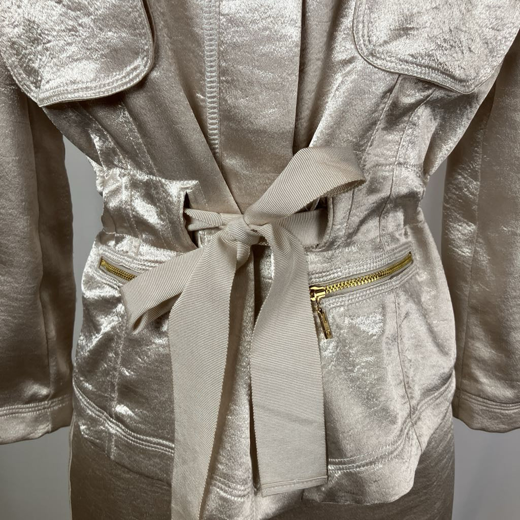Silver metallic jacket with a belt on a gray background