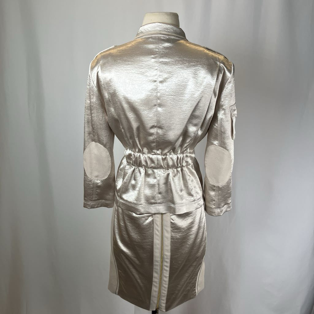 Silver metallic dress on a mannequin against a plain background
