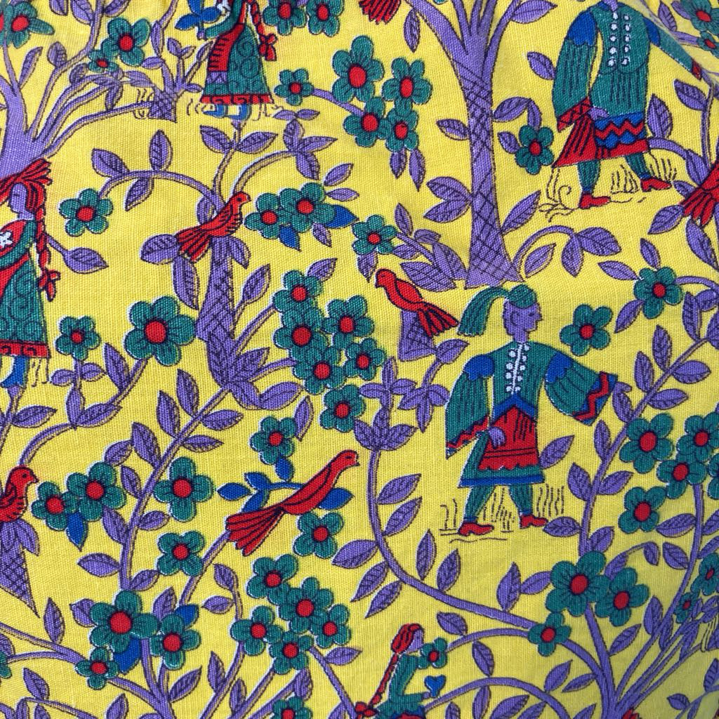 Colorful fabric pattern with people, birds, and trees on a yellow background