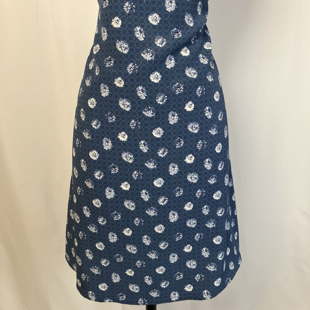 Blue dress with white floral pattern on a beige background