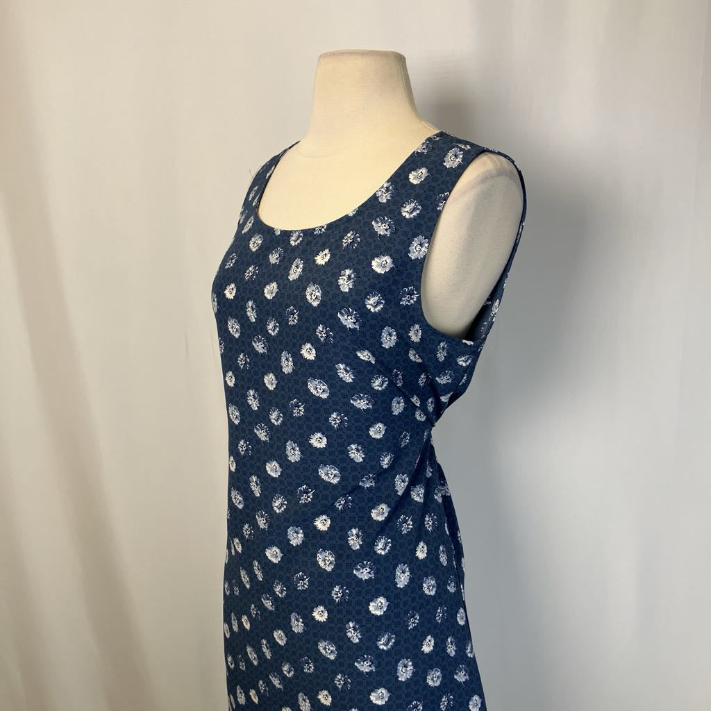 Blue dress with white floral pattern on a mannequin against a plain background