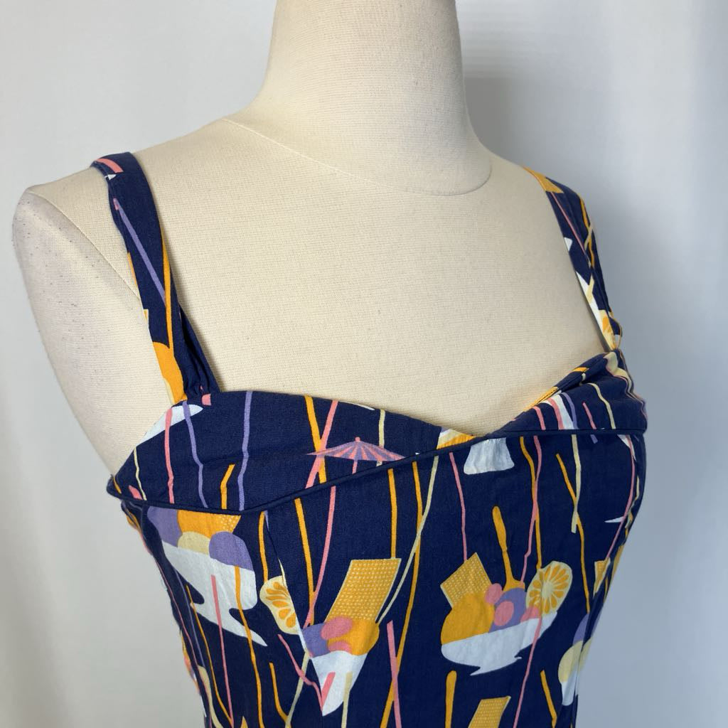 Mannequin wearing a navy dress with colorful abstract pattern on a white background