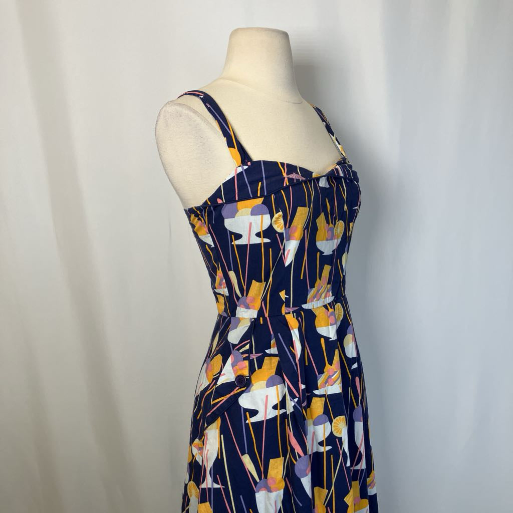 Mannequin wearing a colorful dress with abstract pattern on a plain background