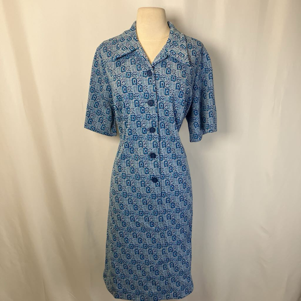 Blue patterned dress on a mannequin against a beige background