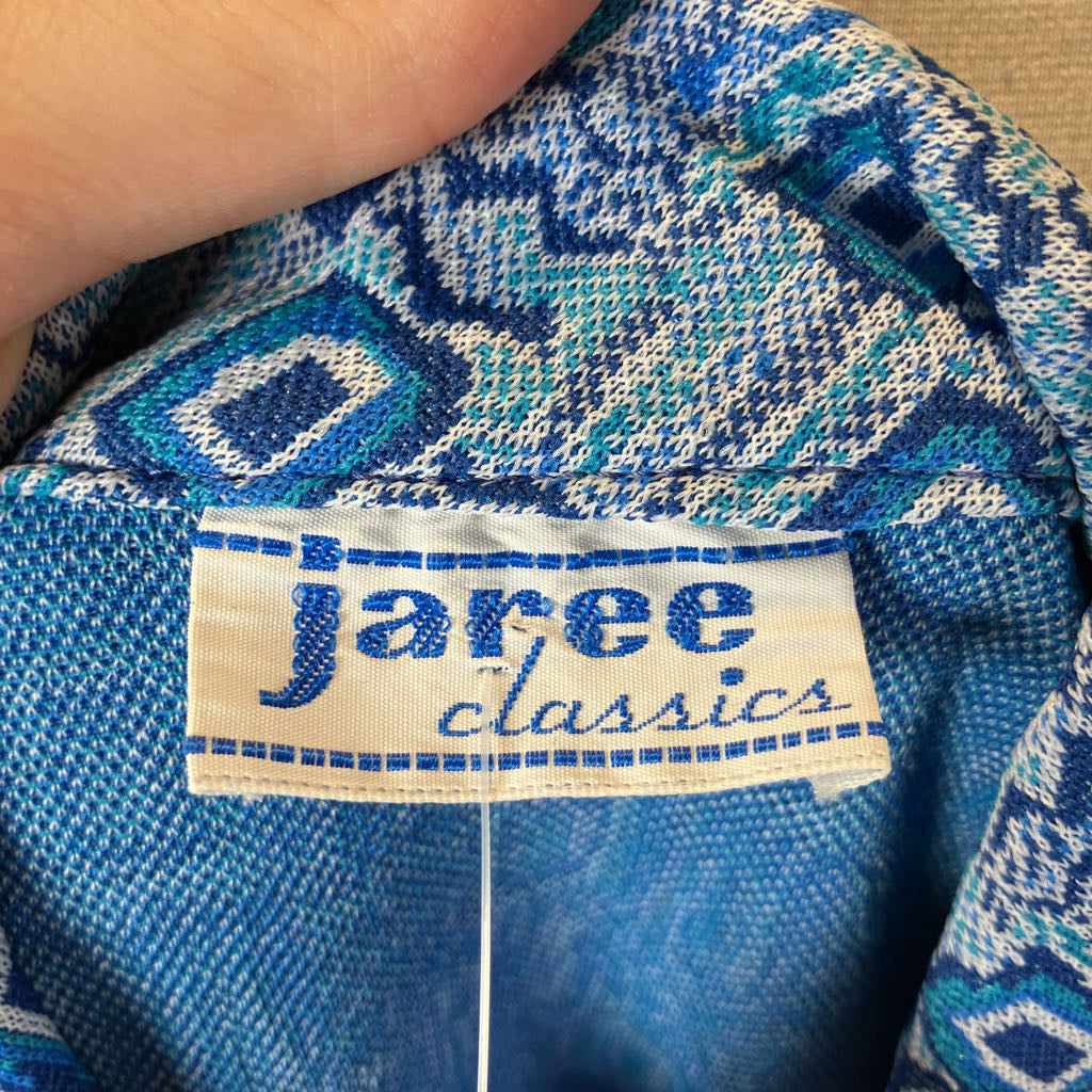 Close-up of a blue patterned fabric with a 'jaree classics' label.