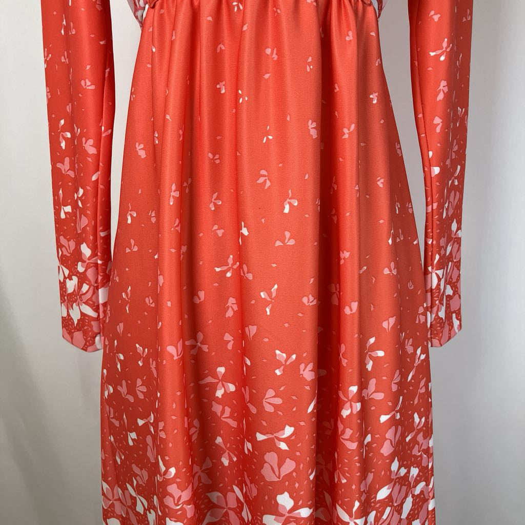 Red dress with white floral pattern on a plain background