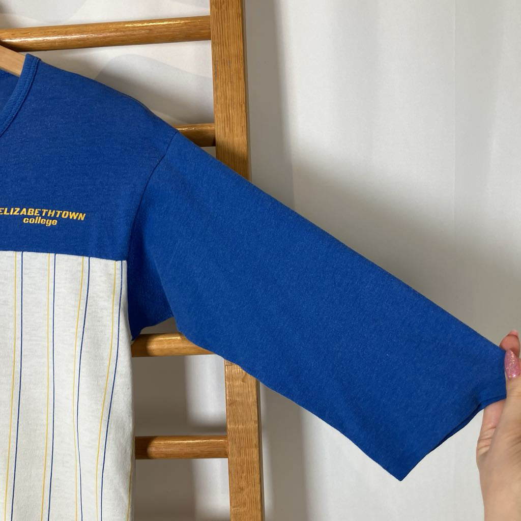 Blue long-sleeve shirt with 'Elizabethtown College' text on a wooden rack.