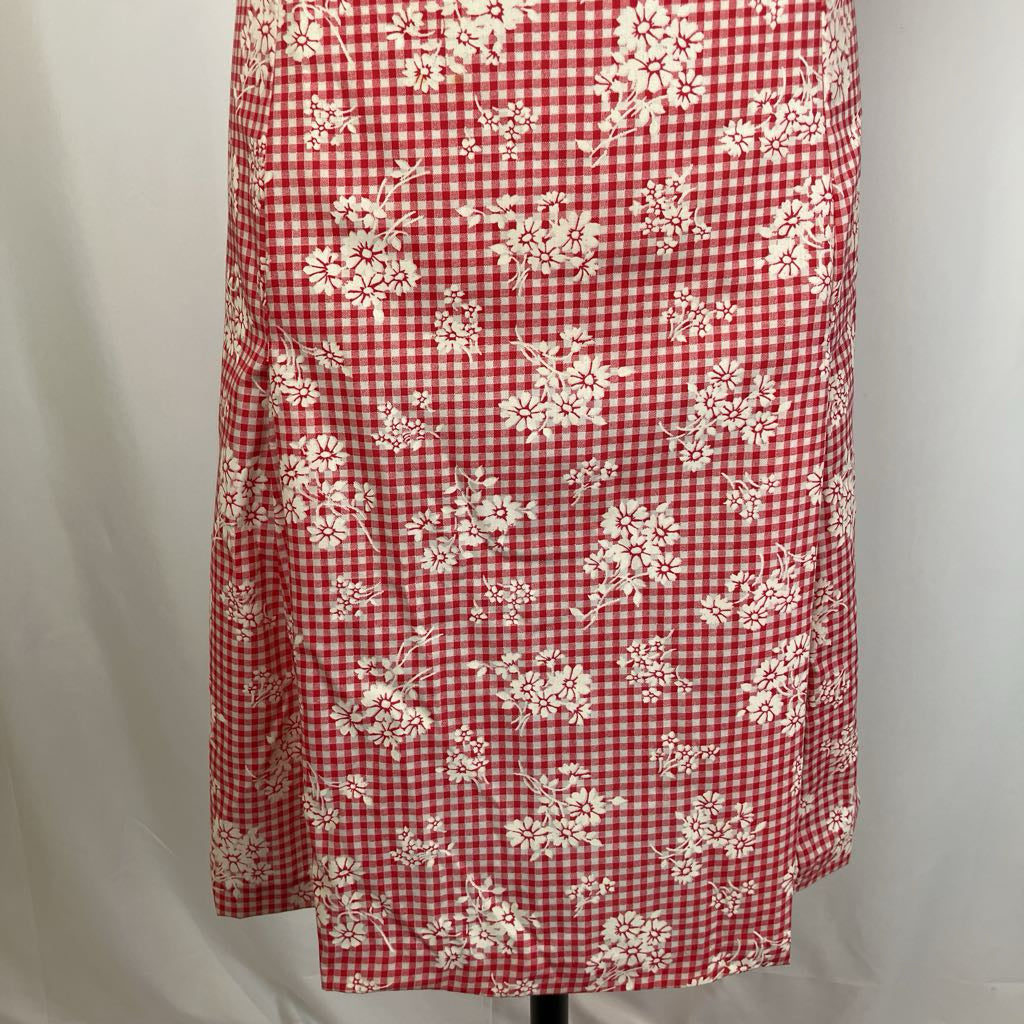 Red and white checkered skirt with floral pattern on a mannequin against a gray background