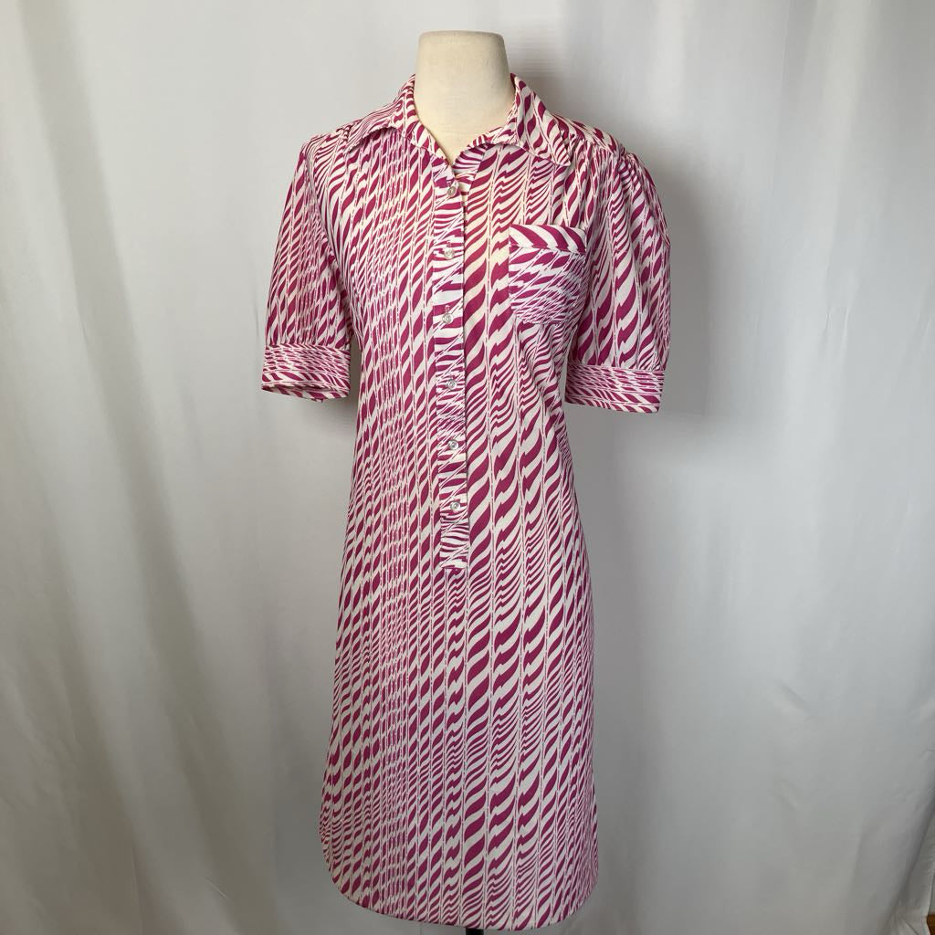 Pink and white patterned dress on a mannequin against a plain background