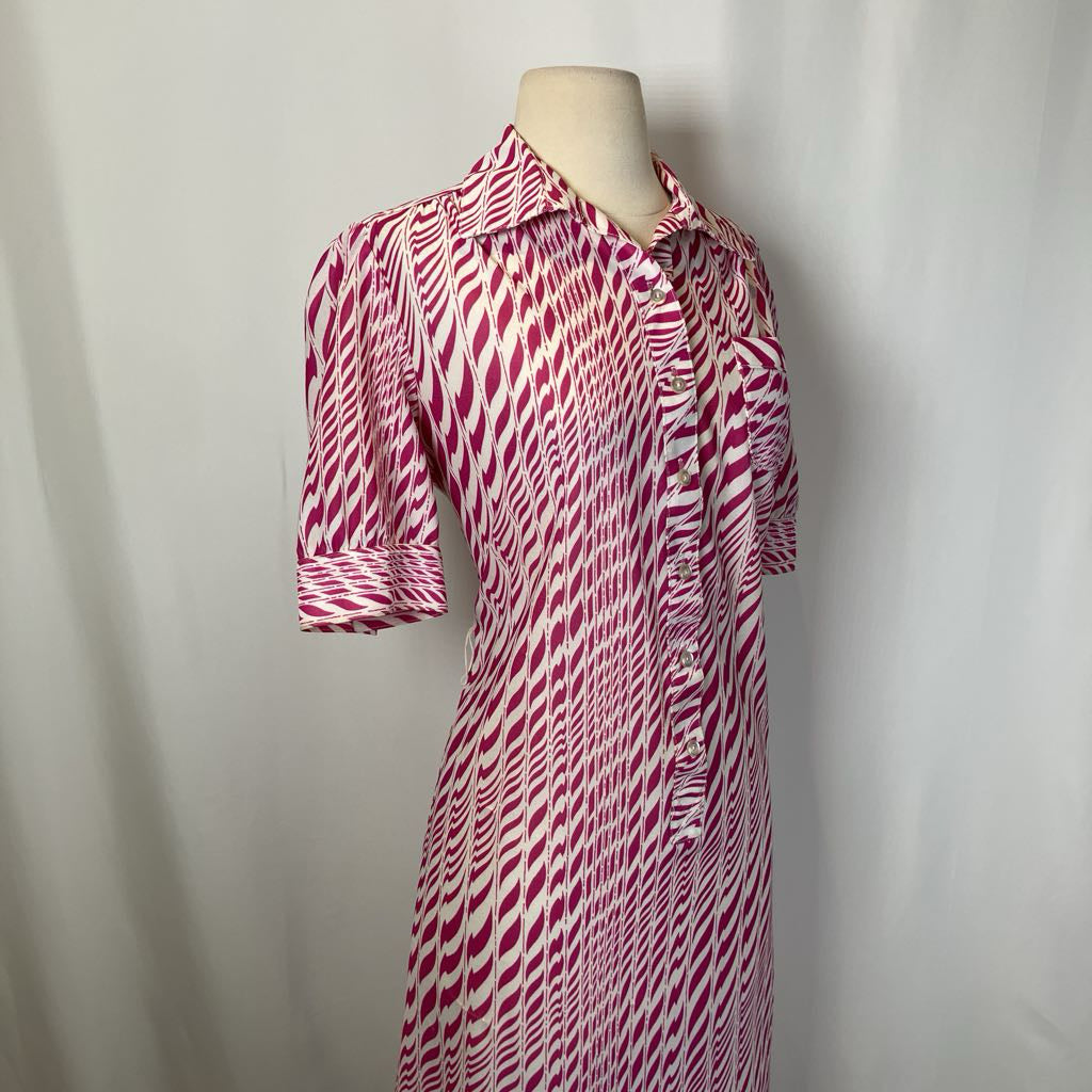 Red and white patterned dress on a mannequin against a plain background