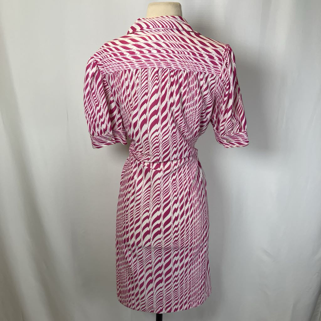 Pink and white patterned dress on a mannequin against a plain background