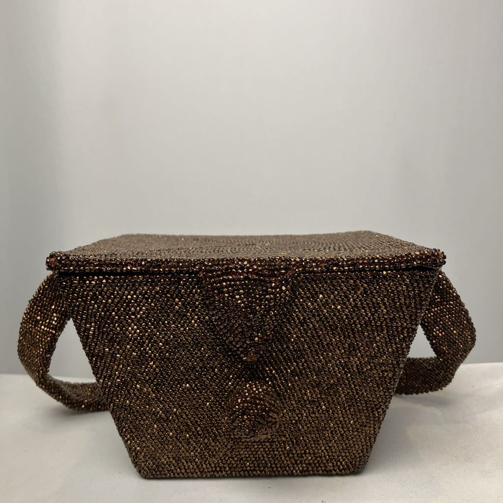 Brown beaded handbag on a light gray background