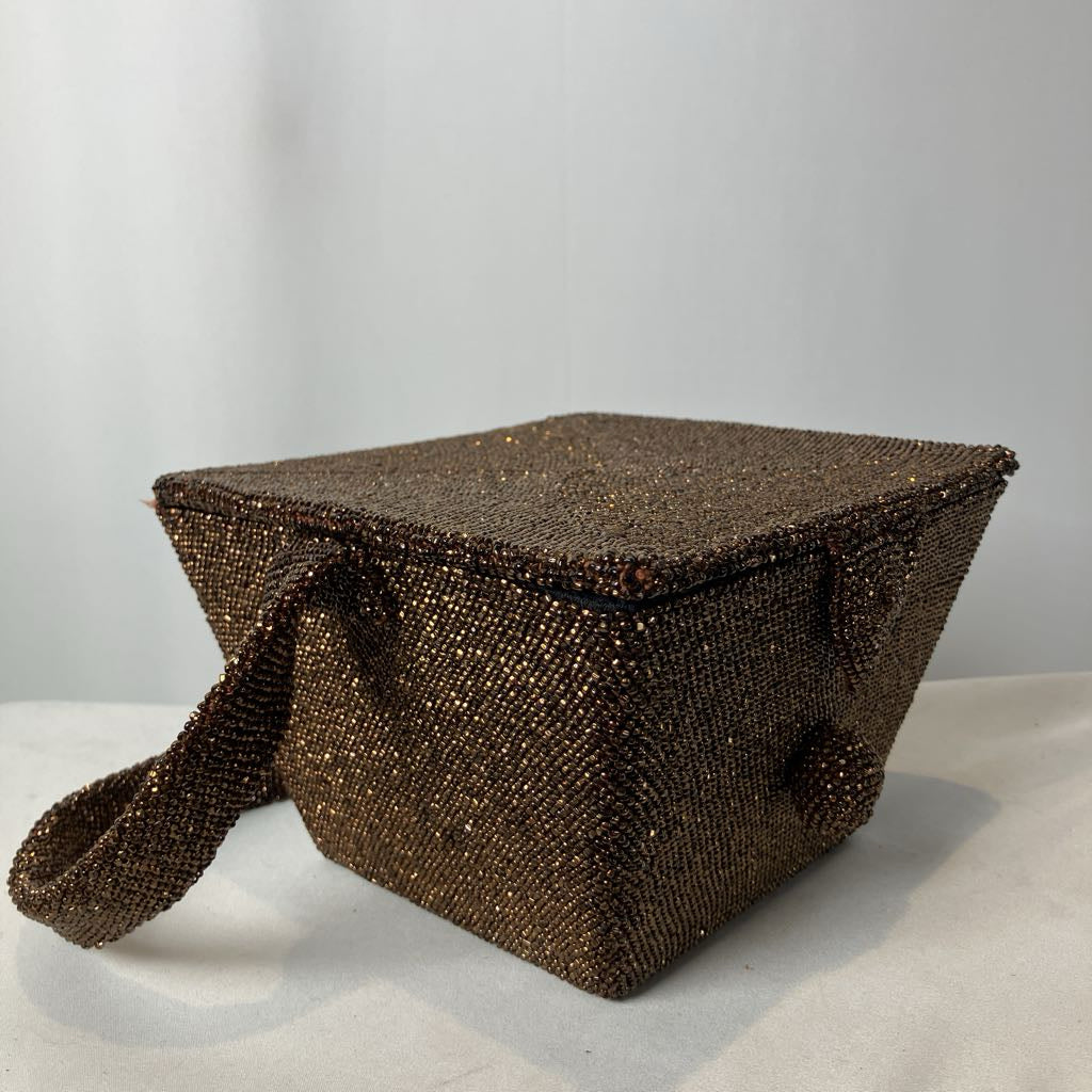 Brown textured bag with a strap on a light gray background