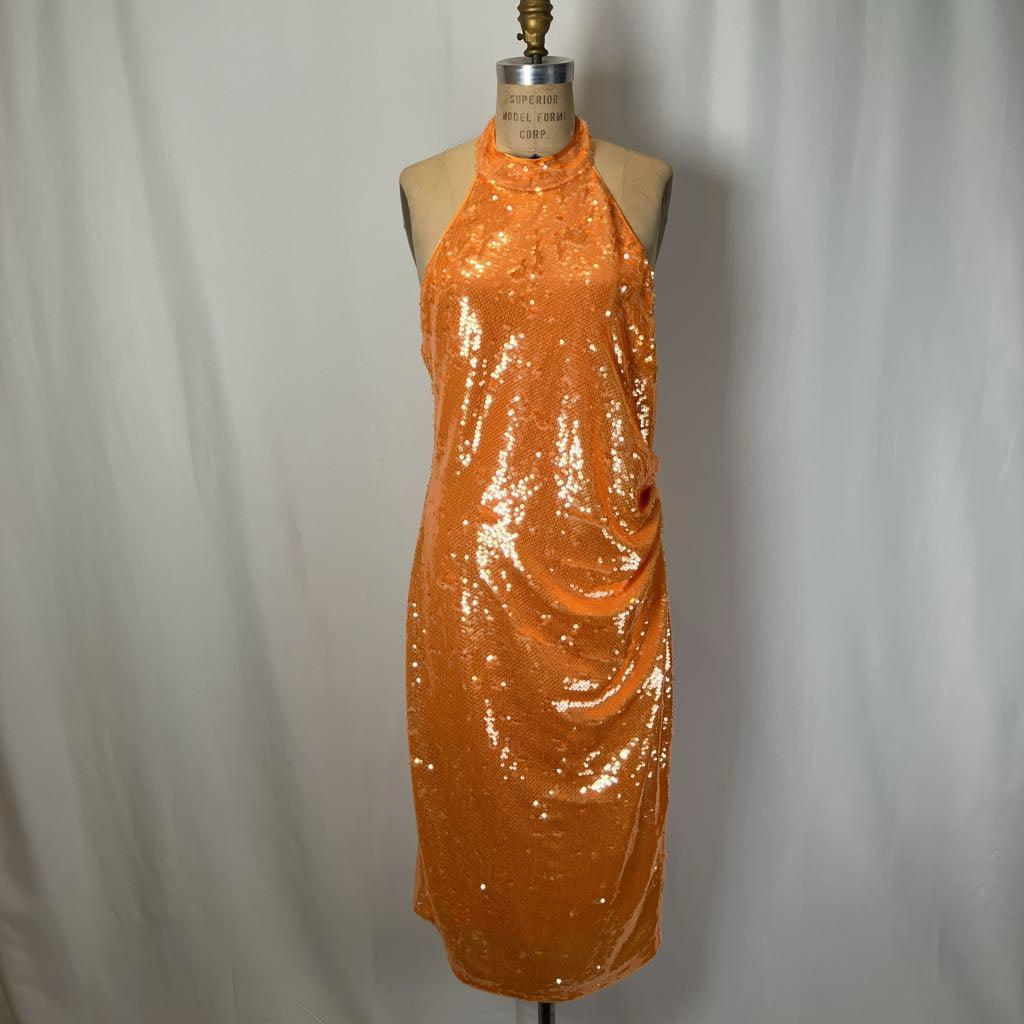 Orange sequin dress on a mannequin against a plain background